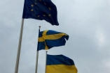 Шведский министр иностранных дел радуется желто-синим флагам как дитя